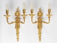 A pair of wall lights in the Louis XVI style.