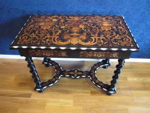 A Napoleon III period (1848 - 1870) marquetry table in Louis XIV style.