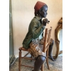 Enfant noir en terre cuite sur une chaise en bambou et cannage. Réf: 356 | Biron Enfant noir en terre cuite sur une chaise en bambou et cannage. Réf: 356
