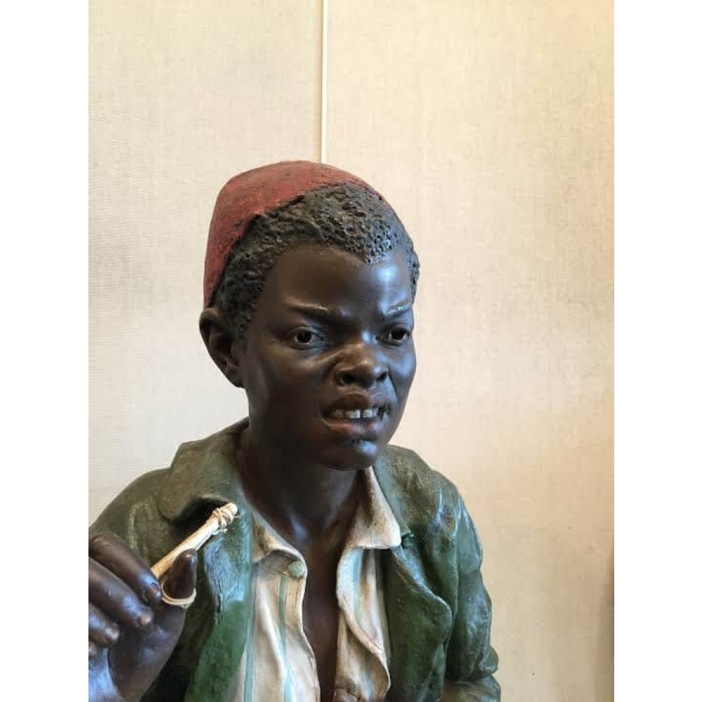 Enfant noir en terre cuite sur une chaise en bambou et cannage. Réf: 356 | Biron Enfant noir en terre cuite sur une chaise en bambou et cannage. Réf: 356