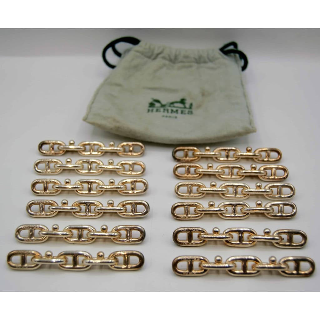 Hermès, 12 porte-couteaux en métal, XXème | Biron Hermès, 12 porte-couteaux en métal, XXème