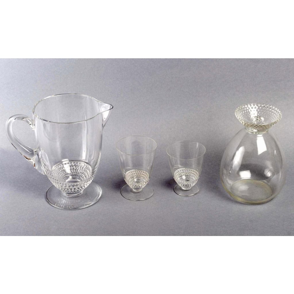 Service « Nippon » verre blanc 26 Pièces (24 Verres + 1 Broc + 1 Carafe) de René LALIQUE | Biron Service "Nippon" verre blanc 26 Pièces (24 Verres + 1 Broc + 1 Carafe) de René LALIQUE