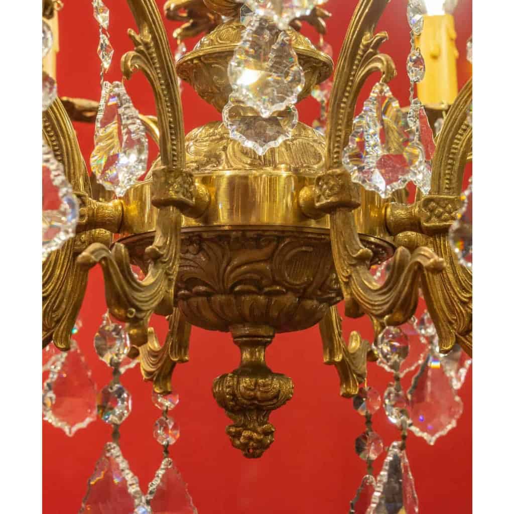 Lustre en bronze à 12 lumières, Louis XV, début XXème siècle | Biron Lustre en bronze à 12 lumières, Louis XV, début XXème siècle