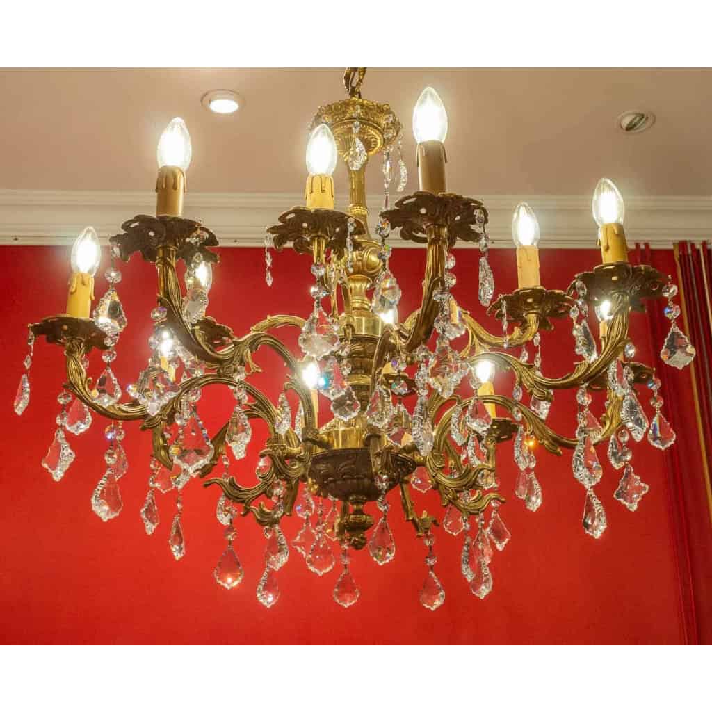 Lustre en bronze à 12 lumières, Louis XV, début XXème siècle | Biron Lustre en bronze à 12 lumières, Louis XV, début XXème siècle