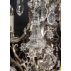 Important lustre avec cage en bronze argenté et cristaux a huit lumières et cinq poignards éclairants