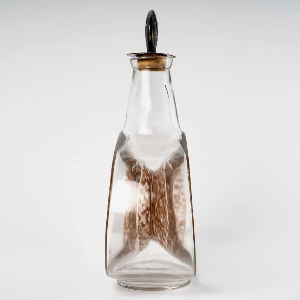 Carafe « Masques » verre blanc patiné sépia de René LALIQUE | Biron Carafe « Masques » verre blanc patiné sépia de René LALIQUE
