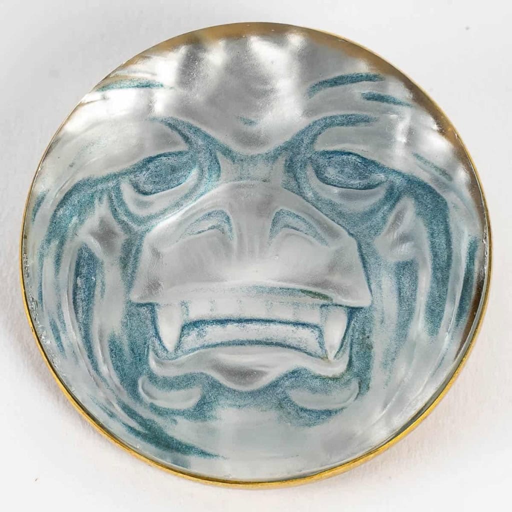 Broche « Masque » verre blanc sur clinquant argent patiné bleu de René LALIQUE | Biron |||||