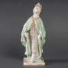 Statuette en porcelaine à couverte émaillée blanc et turquoise, intitulée « Princesse Irène », signée Mougin, Nancy, début du XXe siècle. | Biron Statuette en porcelaine à couverte émaillée blanc et turquoise, intitulée "Princesse Irène", signée Mougin, Nancy, début du XXe siècle.