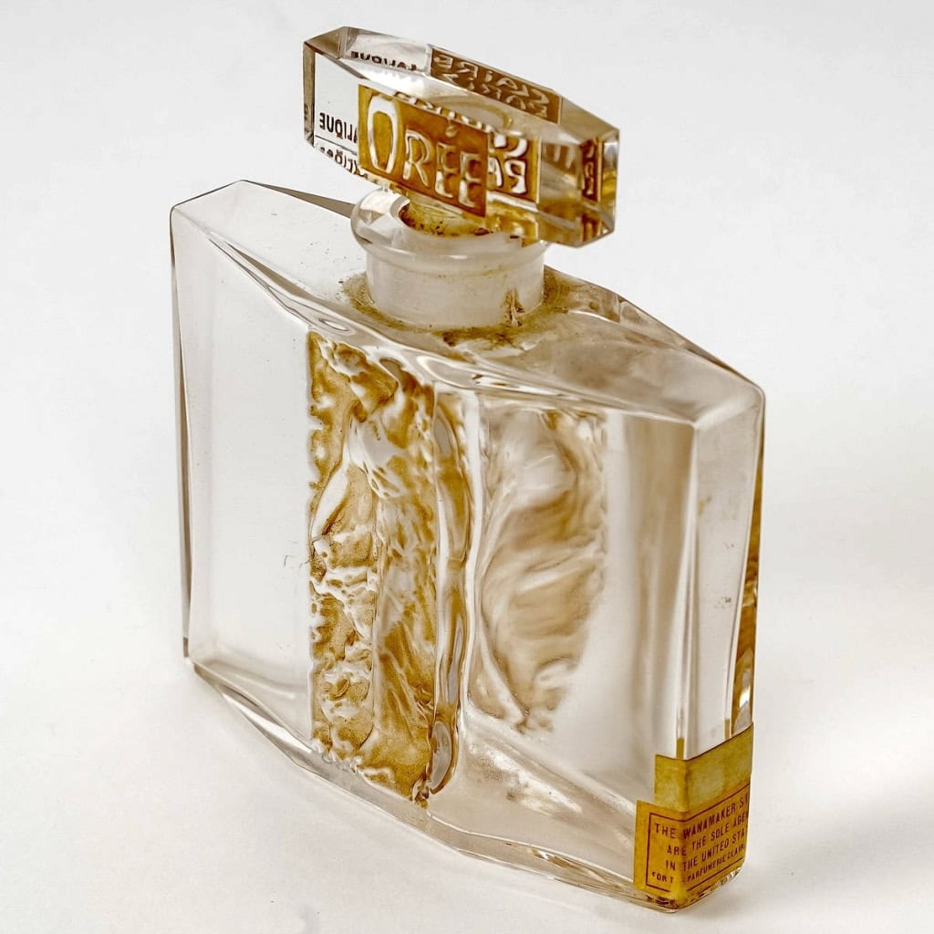 Flacon « L’Orée » verre blanc patiné sépia de René LALIQUE pour Claire Paris | Biron Flacon "L'Orée" verre blanc patiné sépia de René LALIQUE pour Claire Paris