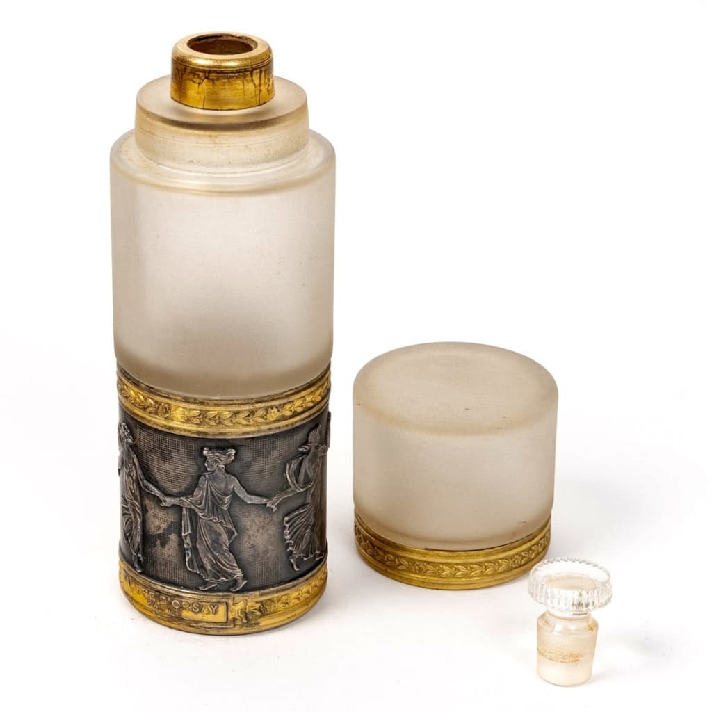 Flacon « Ambre » en cristal blanc de BACCARAT et frise en bronze à décor de femmes de René LALIQUE | Biron Flacon "Ambre" en cristal blanc de BACCARAT et frise en bronze à décor de femmes de René LALIQUE
