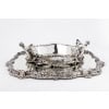 ORFEVRE C.CHRISTOFLE Silver-plated bronze centerpiece called “The Forest” XIX19th century | Biron Silver-plated bronze centerpiece called "The Forest" by C. CHRISTOFLE XIXth century Table centerpiece in silver-plated bronze composed of an oval tray with a mirror base mounted on an oak parquet floor and set with a silver-plated bronze ingot mold with a plant decoration of tree branches, in the center is placed a magnificent planter with the same forest decoration whose handles are represented by two young fauns. This piece was entitled "LA FORÊT". Dimensions: Tray Length 0 cm - width 70 cm - Height 46 cm Planter: length 6 cm - width 48 cm - height 24 cm Material: Bronze Hallmarks: CHRISTOFLE in full CC balance and three stars in a square Order number: 14 and 2365582 Period: Mid-222657th century XIX10th century Goldsmith: CHARLES CHRISTOFLE