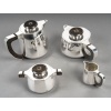 Jean E Puiforcat Service thé café 4 Pièces argent massif ART DECO | Biron Jean E Puiforcat Service thé café 4 Pièces argent massif ARTT DECO Service thé/café 4 pièces en argent massif modèle à pans coupé, anses en argent et prises stylisées en bois et argent, composé d’une cafetière, d’une théière, d’un pot à lait et d’un sucrier couvert. Monogramme LD. Dimensions : Cafetière : 20,5 cm x 13 cm x 15 cm (hauteur) - Poids : 918 grs Théière : 23 cm x 14 cm x 10,5 cm - Poids : 910 grs Sucrier : 16 cm x 11 cm x 8,5 cm - Poids : 450 grs Pot à lait : 11 cm x 7 cm x 7 cm - Poids : 192 grs Matière : Argent 1er titre 950/°°° Poids total : 2 470 Grammes Poinçon : MINERVE Orfèvre : JEAN E. PUIFORCAT Origine : France/Paris