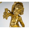 Paire de bougeoirs d’époque Napoléon III à décor de Putti en bronze doré, montée en lampes | Biron 