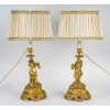 Paire de bougeoirs d’époque Napoléon III à décor de Putti en bronze doré, montée en lampes | Biron 