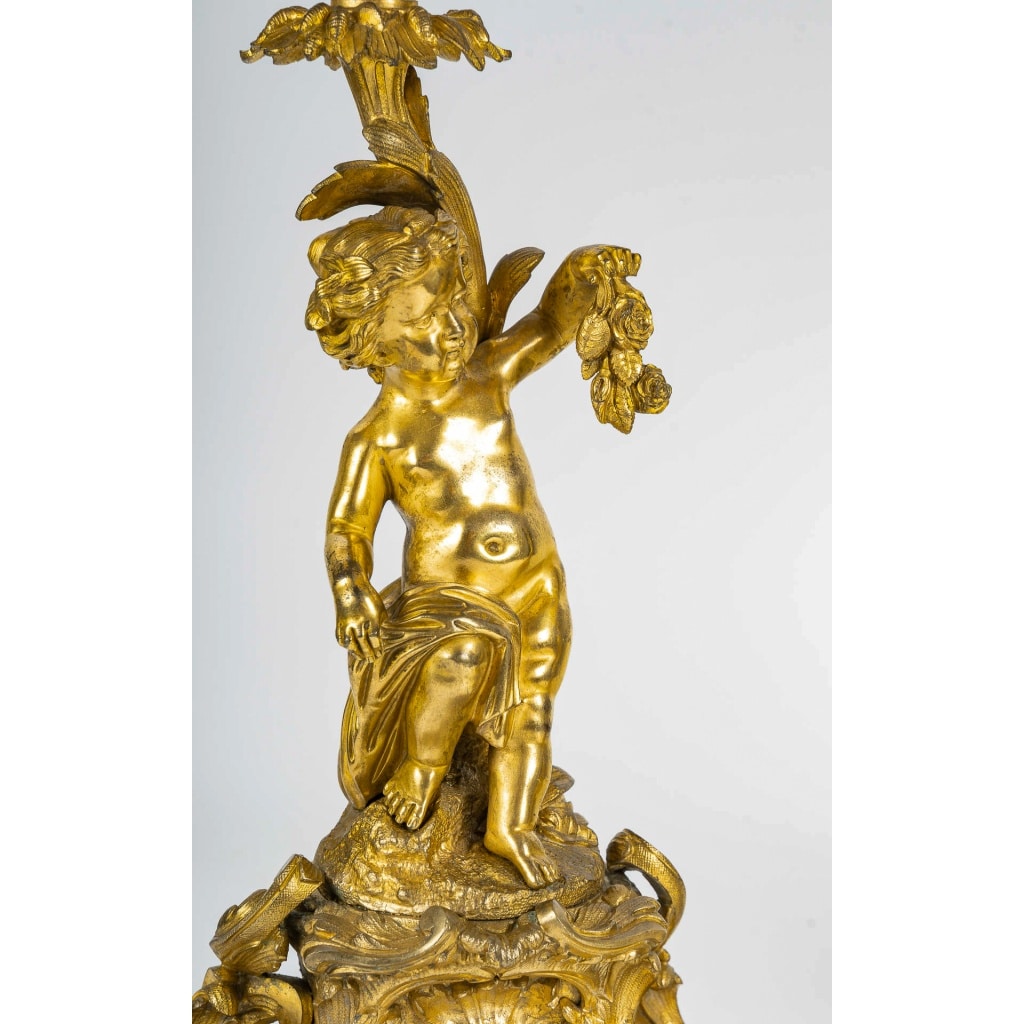 Paire de bougeoirs d’époque Napoléon III à décor de Putti en bronze doré, montée en lampes | Biron 