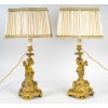 Paire de bougeoirs d’époque Napoléon III à décor de Putti en bronze doré, montée en lampes | Biron 